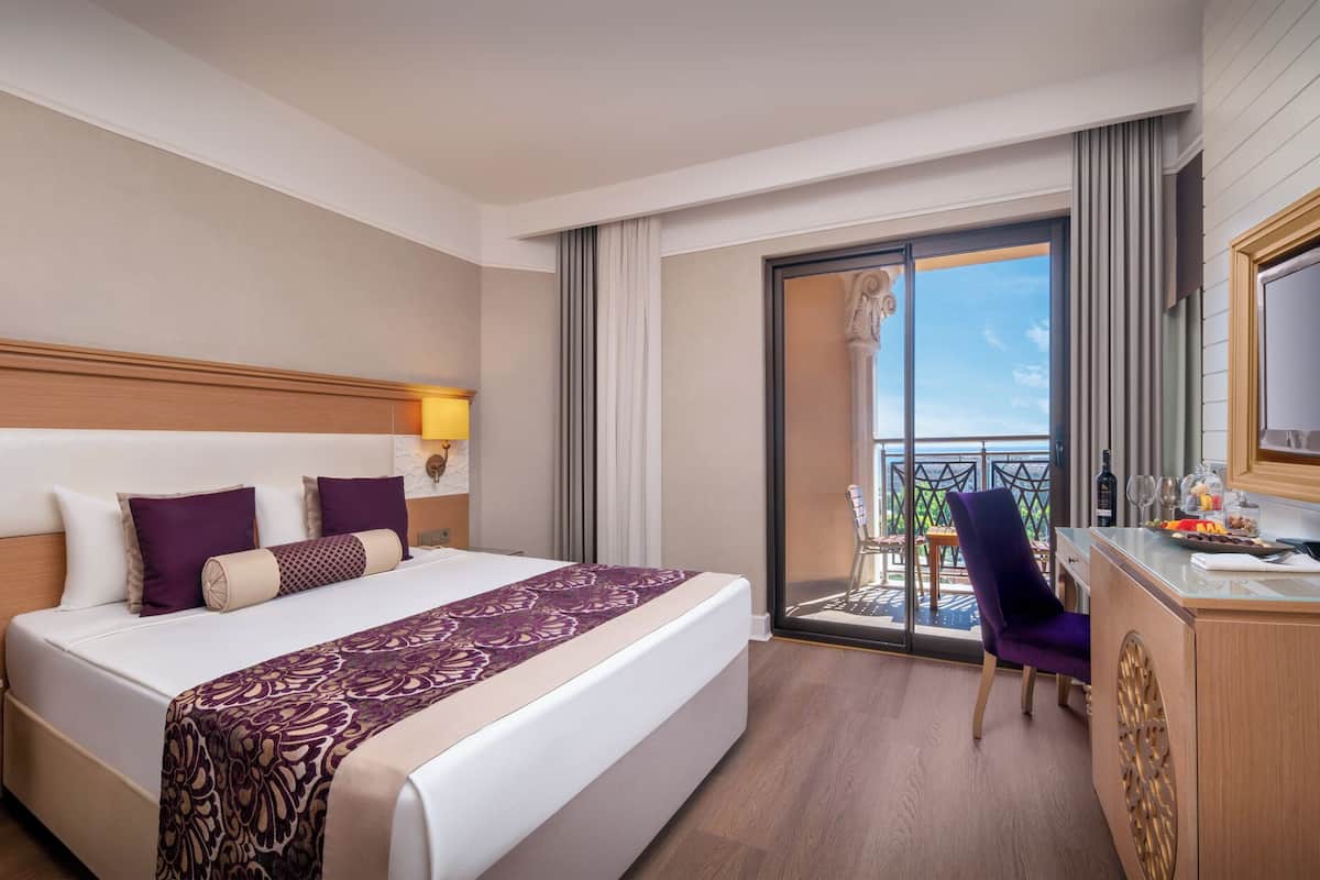 family room | minibar, in-room safe, desk, blackout curtains