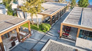 A rooftop terrace with outdoor seating, a pool, and a view of boats on the water. - Voyage Torba (Bodrum)