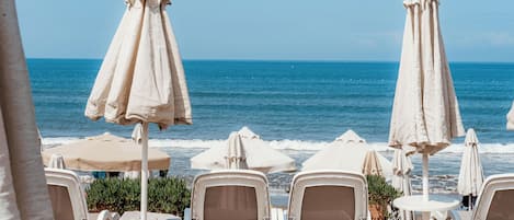 En privat strand, liggestole, parasoller