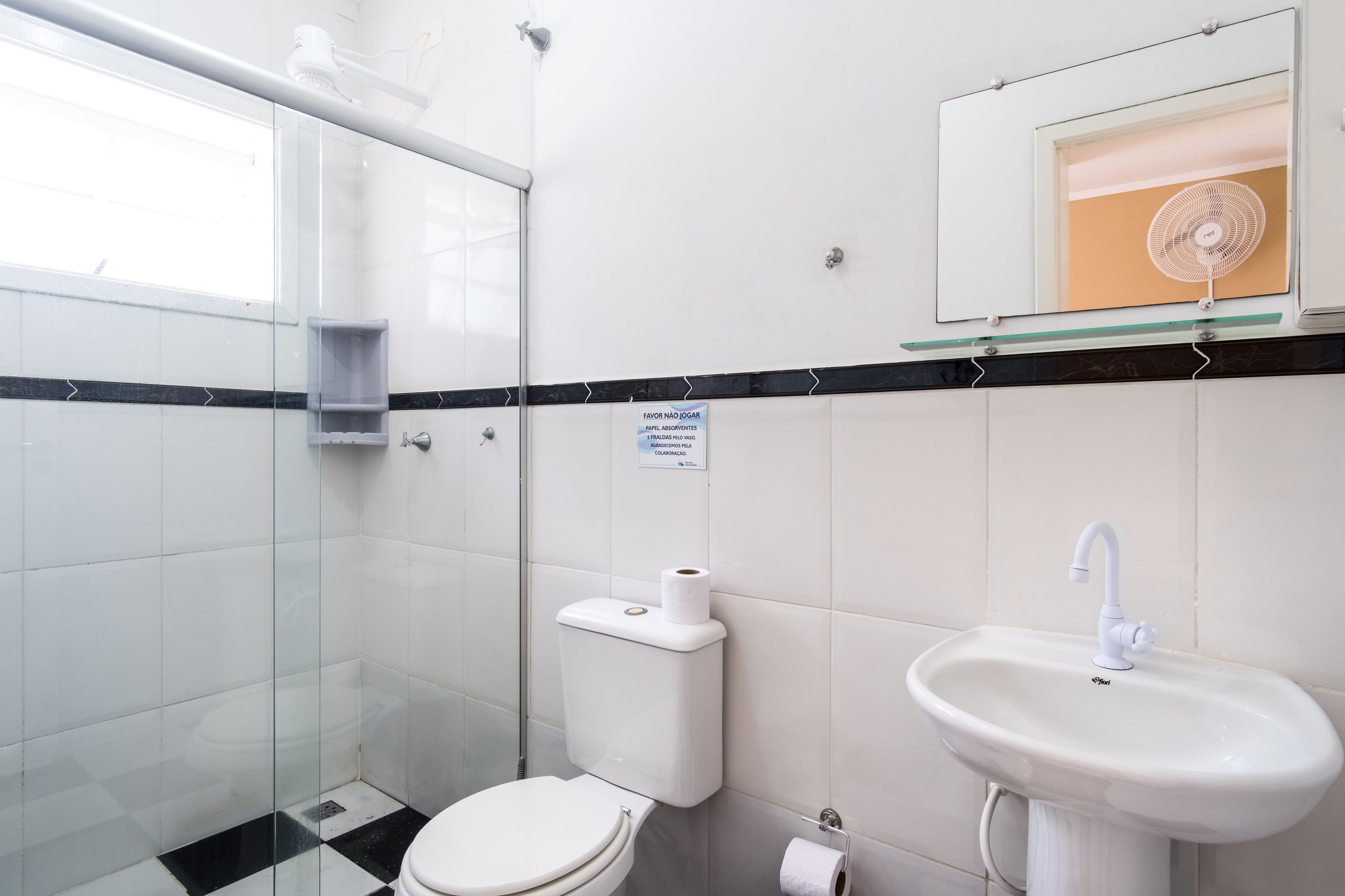A modern bathroom with a glass shower enclosure, a toilet, and a sink.