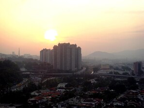 A high-rise building with a view of the sunset over a cityscape. - Duta Hotel & Residence (Kuala Lumpur)
