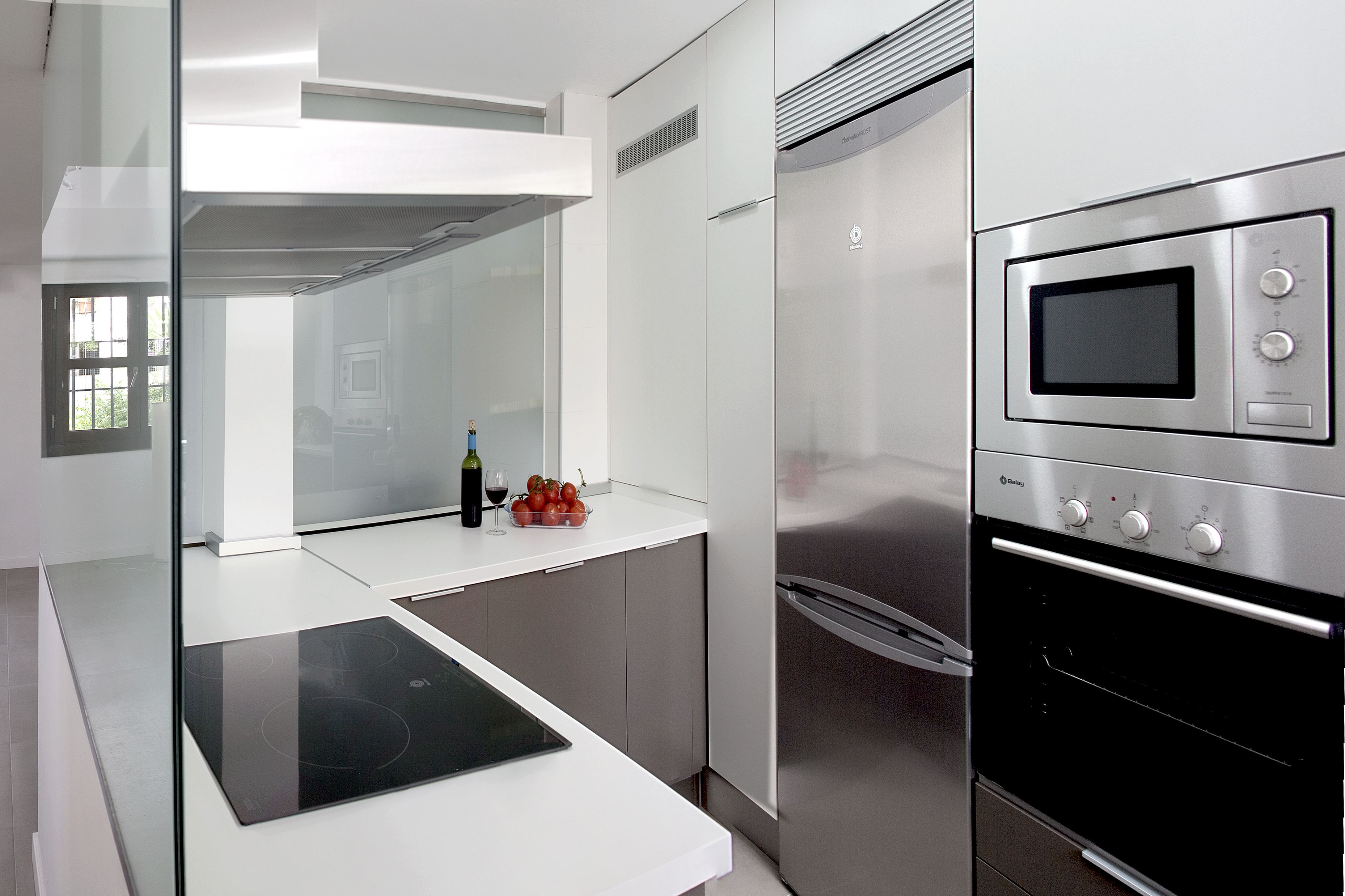 A modern kitchen with a built-in oven, a microwave, and a stovetop.