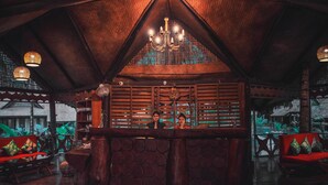A cozy, rustic interior with a wooden ceiling, a central bar area, and comfortable seating. - SilverSand Beach Resort (Port Blair)