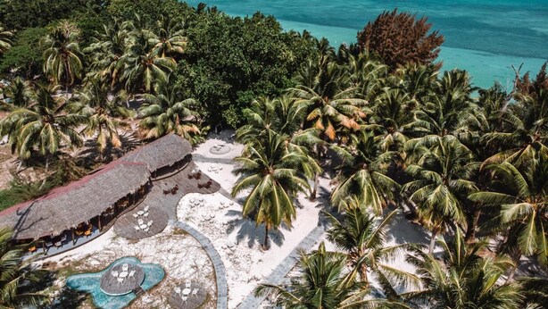 A tropical resort with palm trees, a pool area, and a beach. - SilverSand Beach Resort (Port Blair)