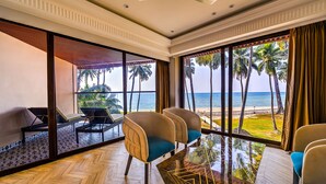 A spacious room with a large window overlooking a beach, furnished with several chairs and a table. - Silver Sand Sea Princess Beach Resort (Ferrurgunj)