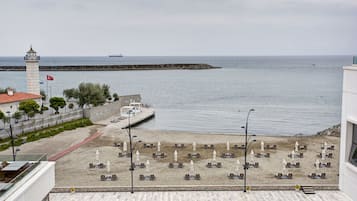 Enjoy stunning ocean views from the balcony, with access to a beach area featuring sun loungers and umbrellas.