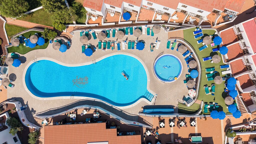 Una piscina al aire libre, sillones reclinables de piscina