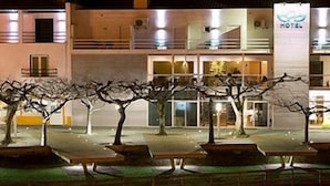 A hotel with a modern facade, outdoor seating area, and a sign indicating it is a hotel. - Sever Rio Hotel (Marvao)