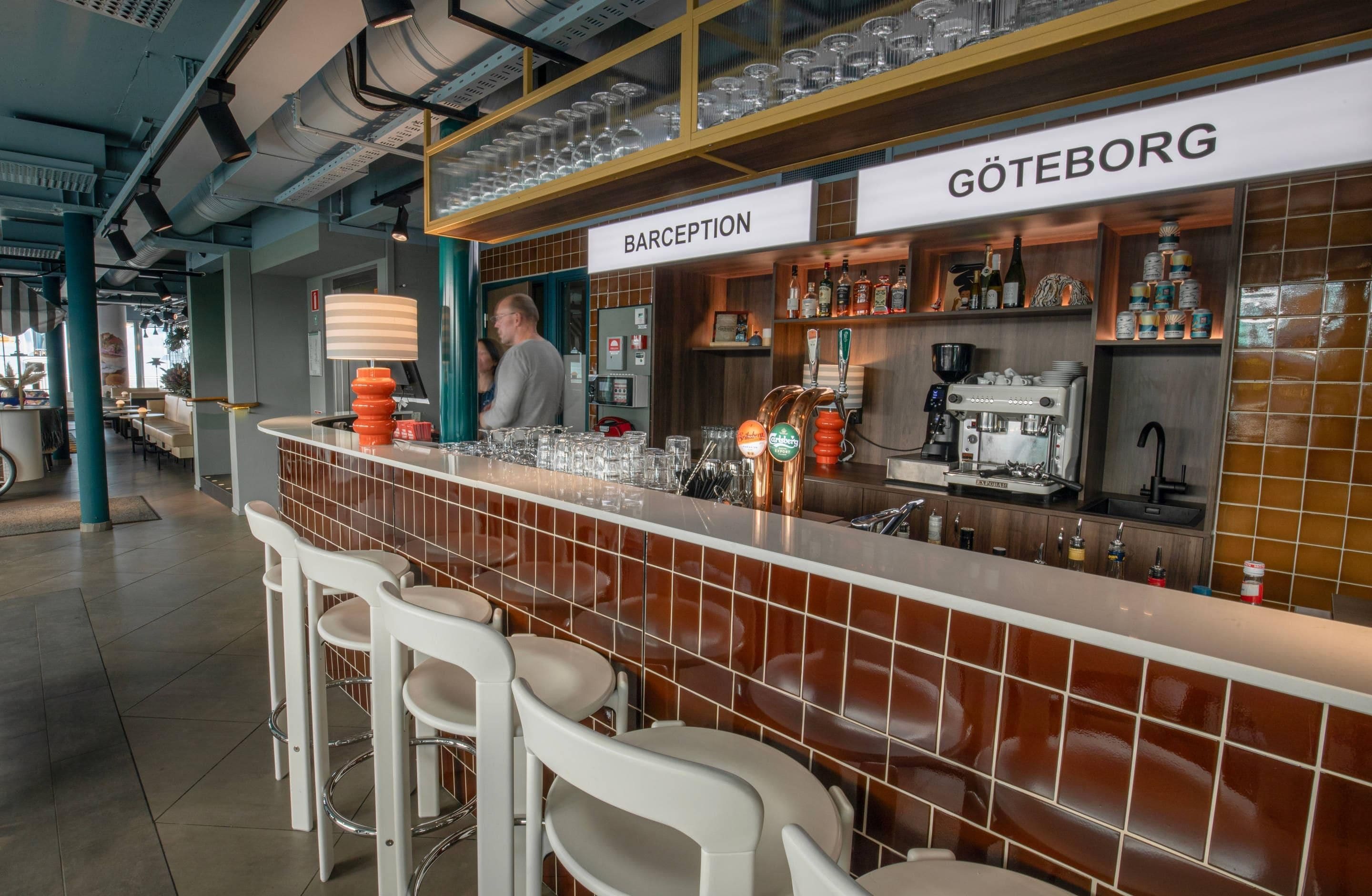 Zona de bar con taburetes, una barra y un cartel que dice 'GÖTEBORG'.