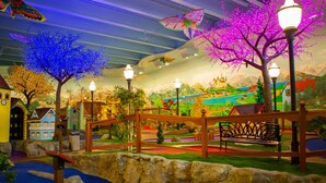 A miniature village with a bridge, a bench, and a small water feature. - Bavarian Inn of Frankenmuth (Frankenmuth)