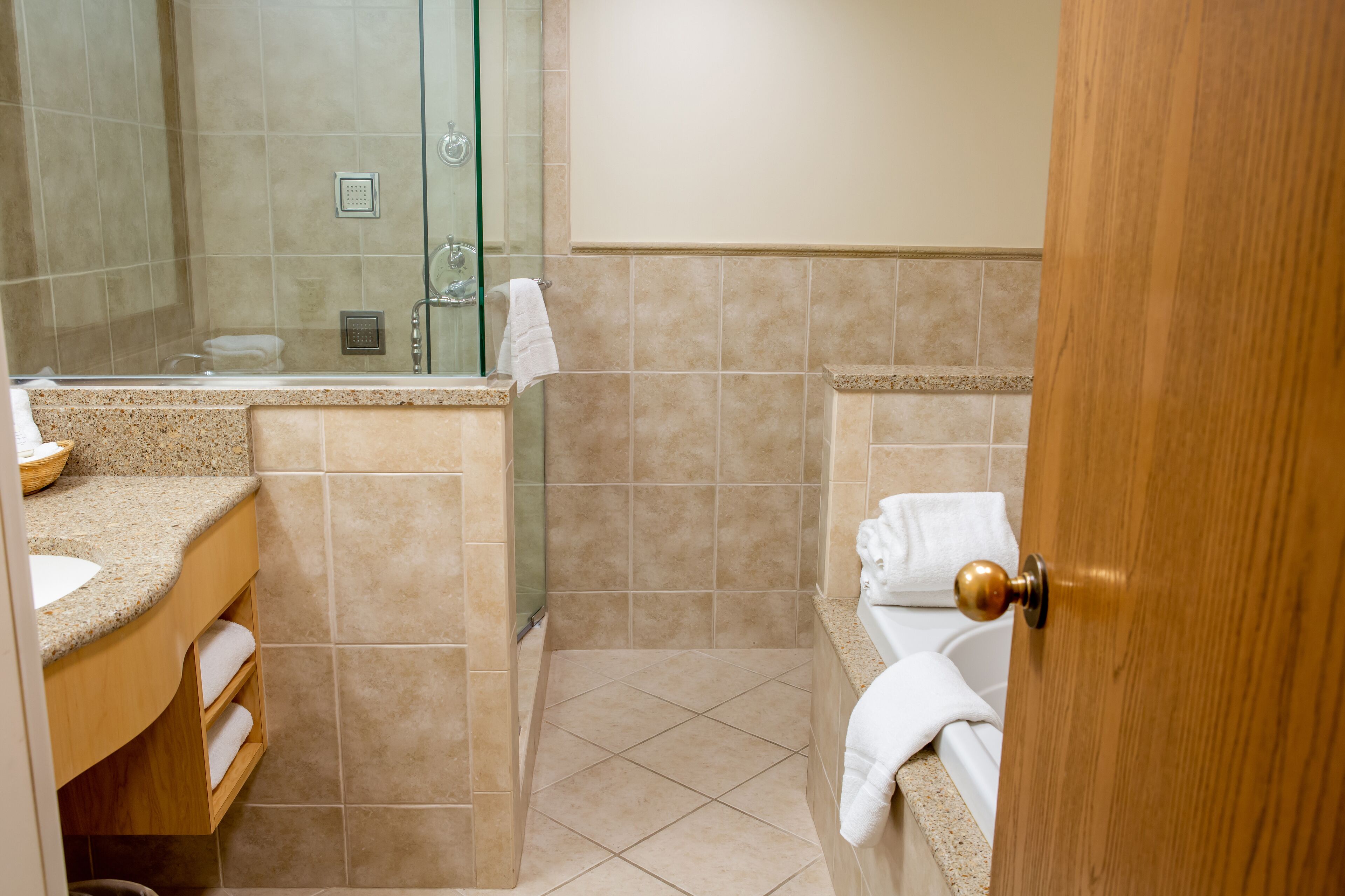 A bathroom with a shower, a sink, and a toilet.
