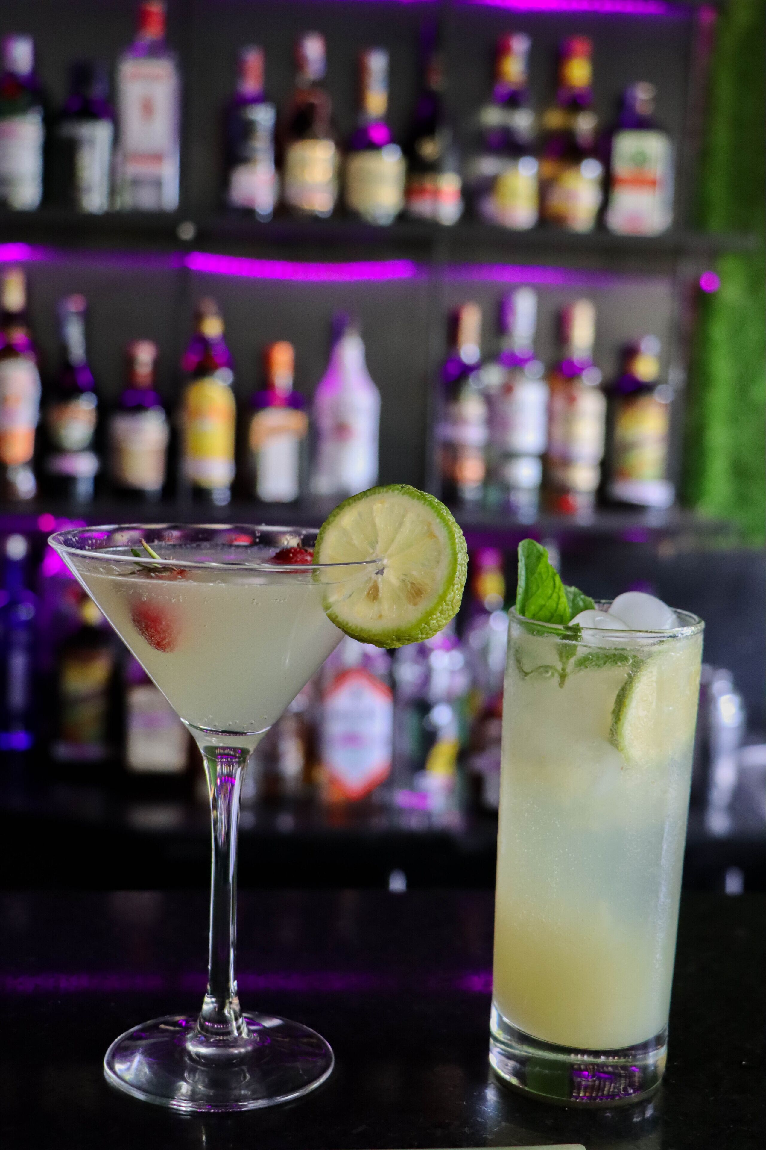 A bar with a variety of bottles in the background.
