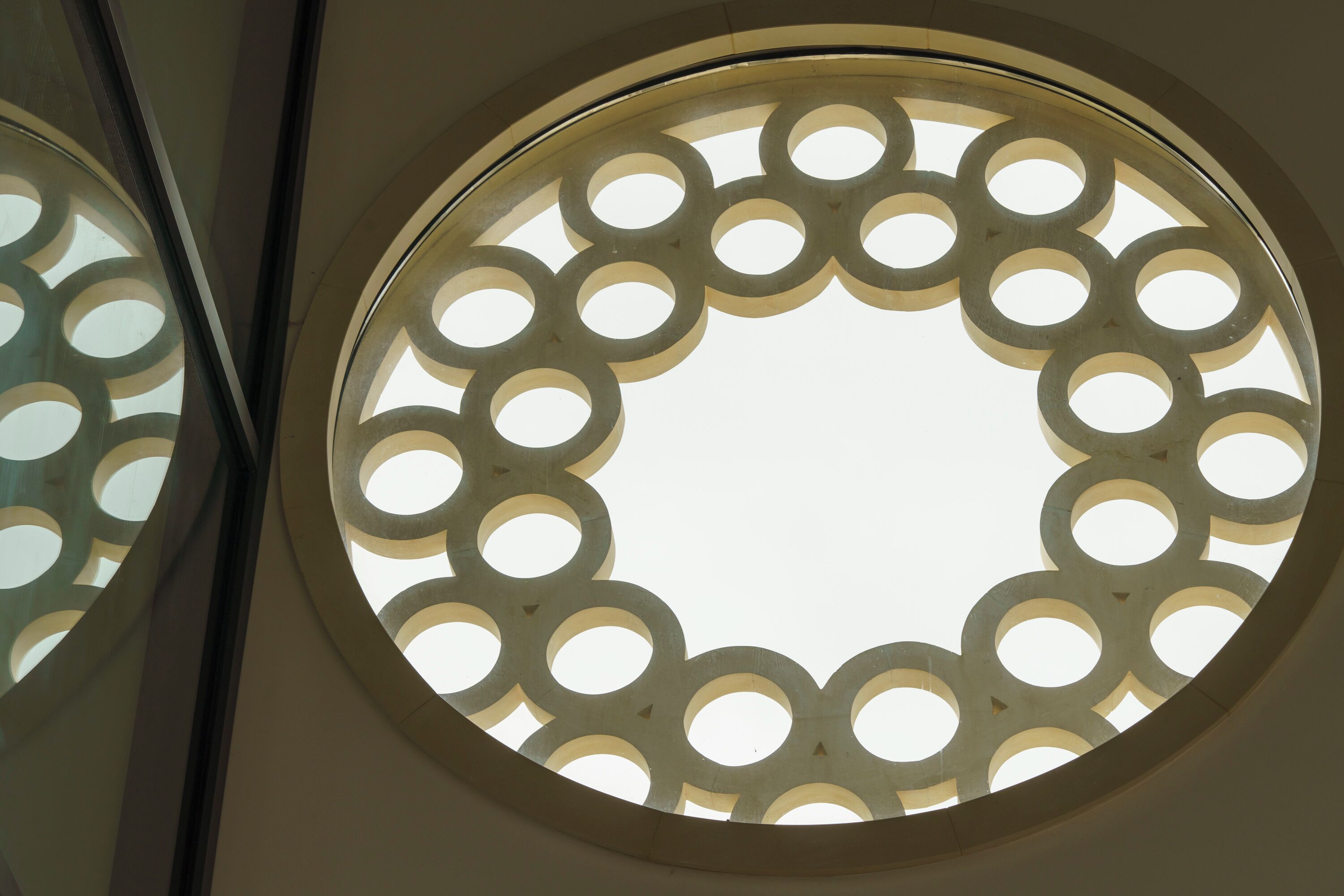 A circular window with a geometric pattern of circles.