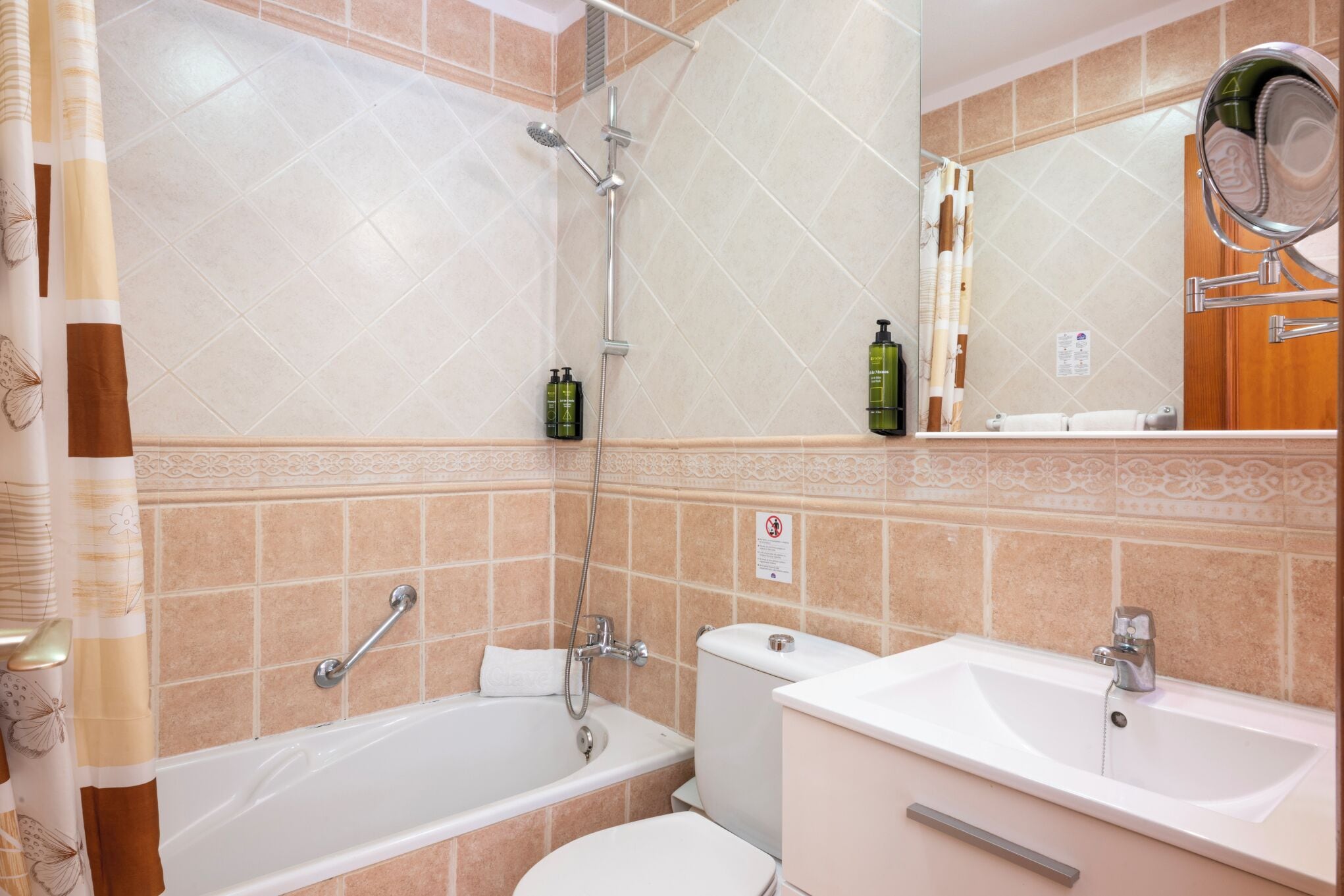 A bathroom with a bathtub, a toilet, a sink, and a shower.