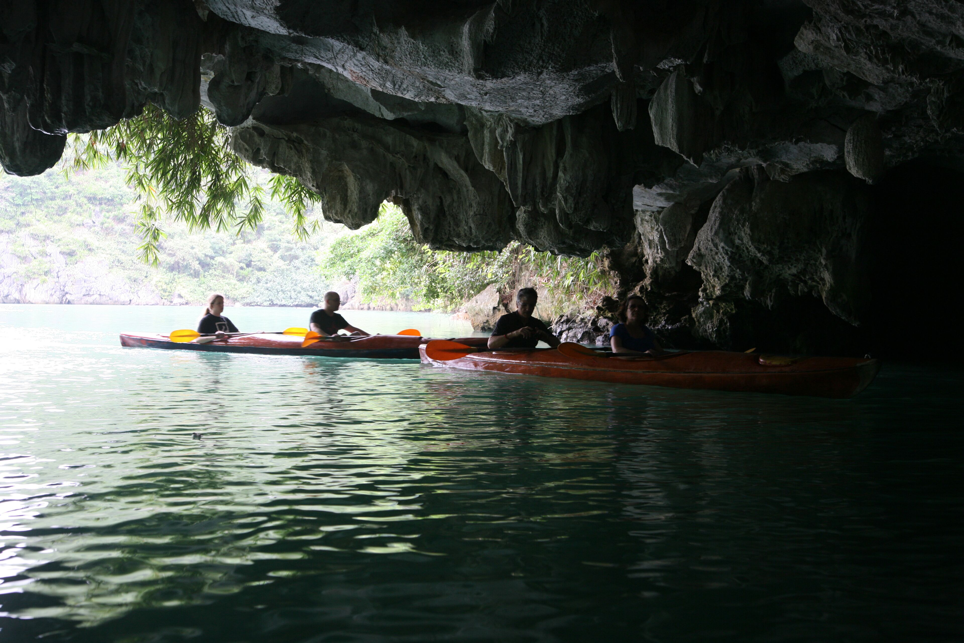 A cave with a water body and kayaks.