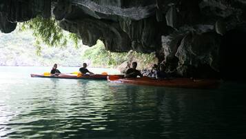 A cave with a water body and kayaks.