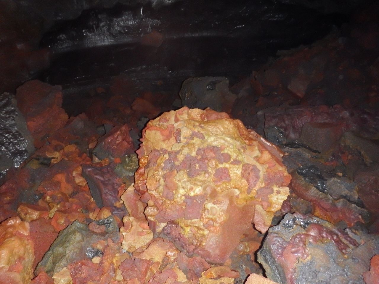 A close-up of a rocky surface with variously colored stones.