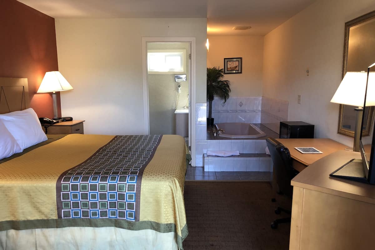 Standard Room, 1 King Bed, Smoking, Jetted Tub | Pillowtop beds, desk, blackout drapes, iron/ironing board