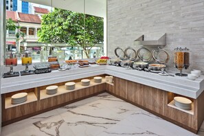 A breakfast buffet with various food items and a marble-tiled floor. - Holiday Inn Express Singapore Serangoon by IHG (Singapore)