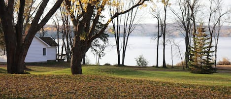 A house with a lawn and trees in the foreground.