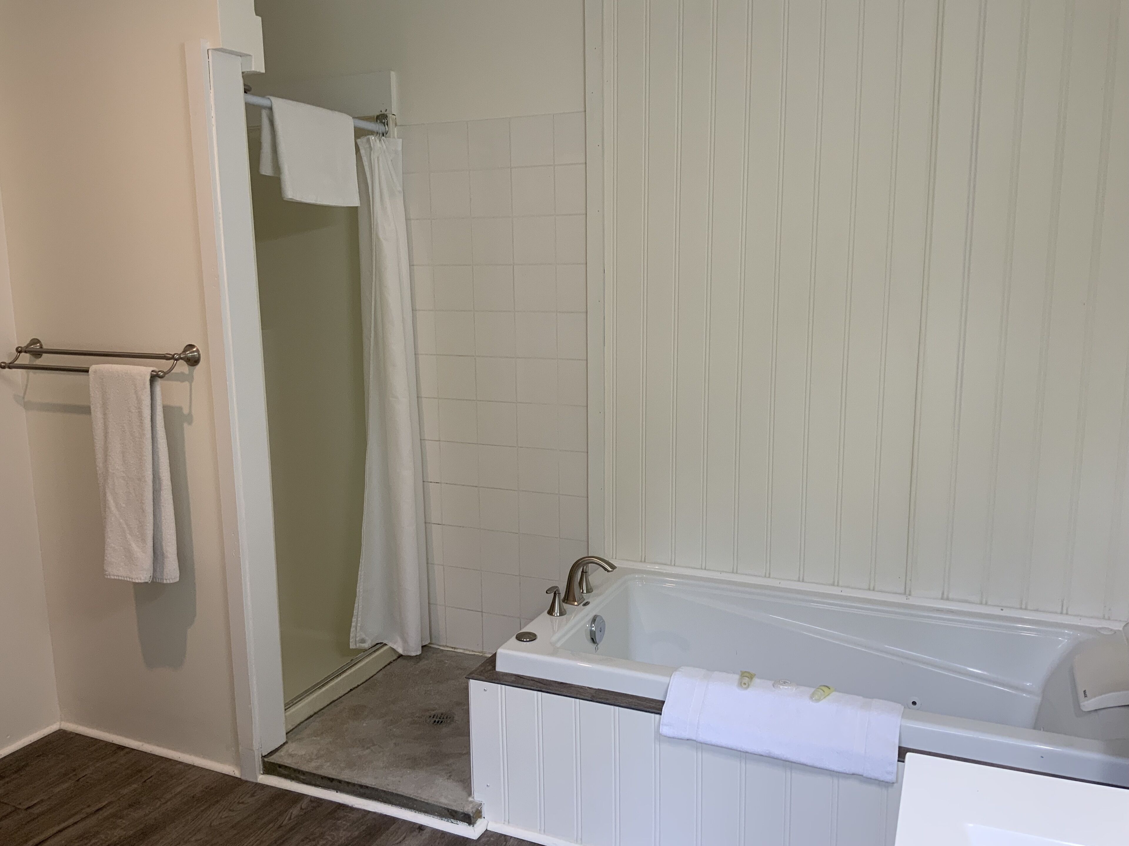 A bathroom with a bathtub, a shower, and a toilet.