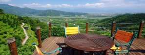 Enjoy a serene view from this deck overlooking lush green landscapes and rolling hills.