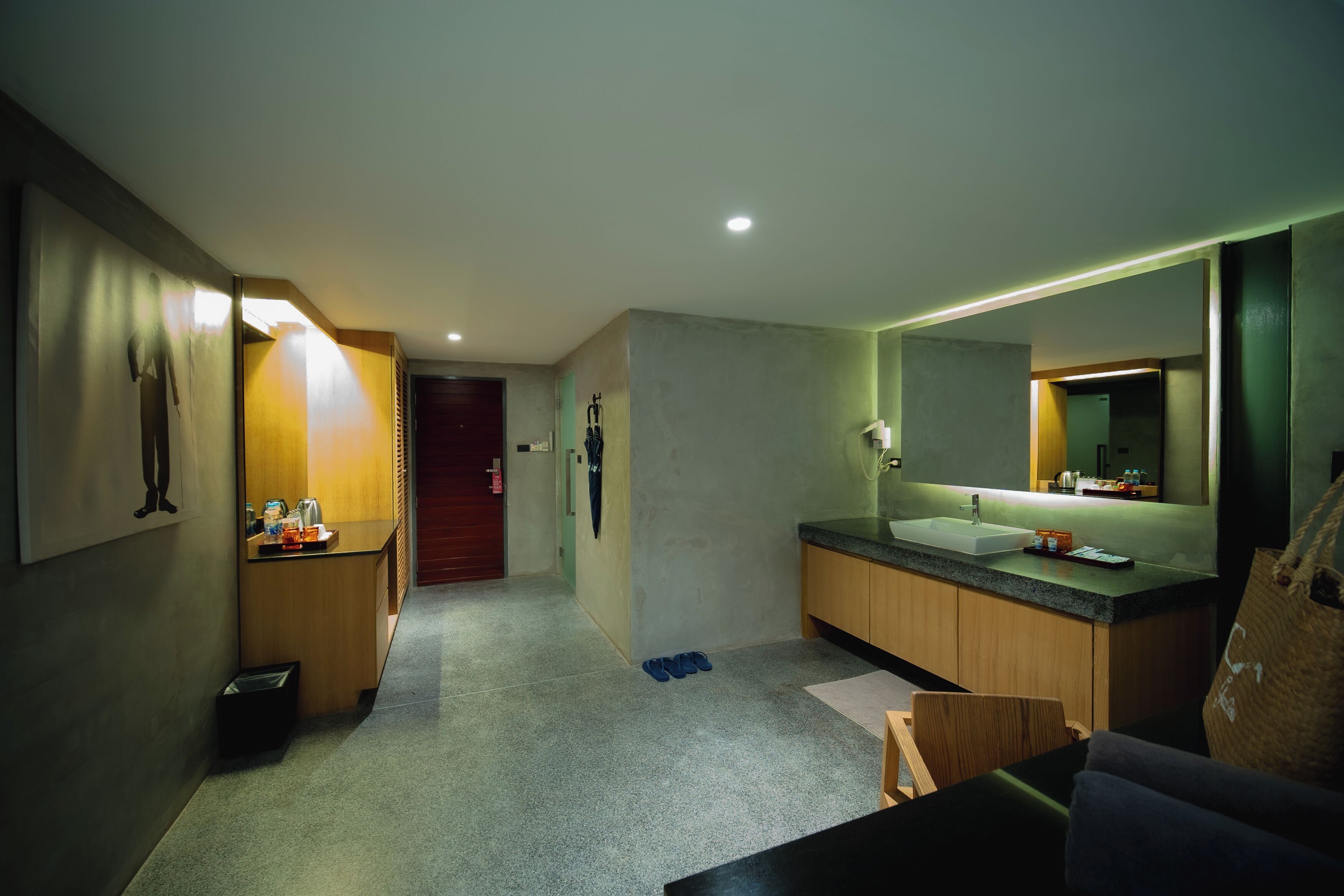 A modern bathroom with a large mirror, a sink, and a shower area.