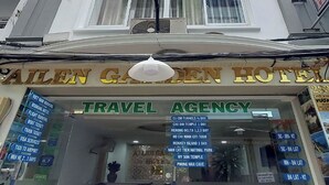A travel agency named 'AILEN GARDEN HOTEL' with a signboard listing various travel services and destinations. - Ailen Hotel (Ho Chi Minh City)