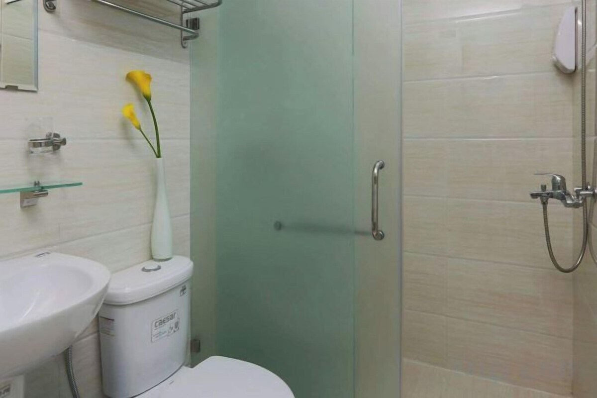 A bathroom with a toilet, bidet, and shower.