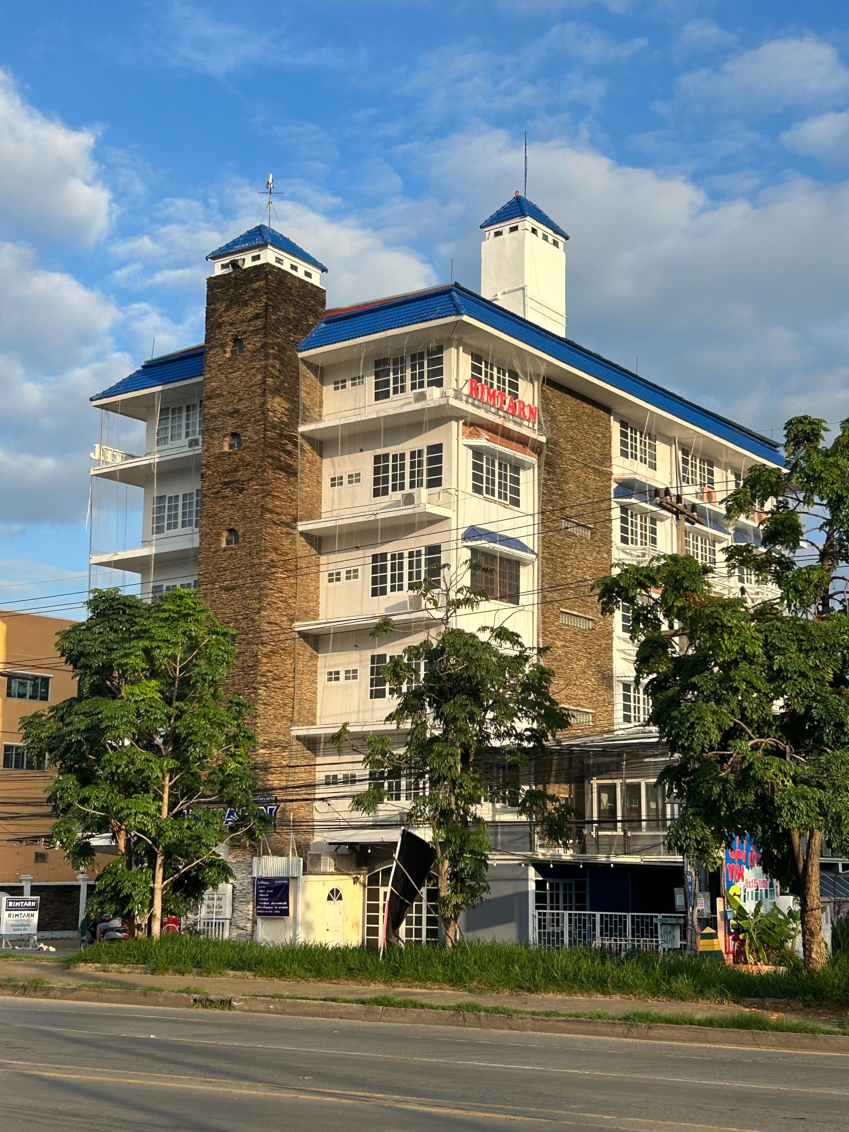 A multi-story building with a prominent sign reading 'RIMTARAN' on the facade.