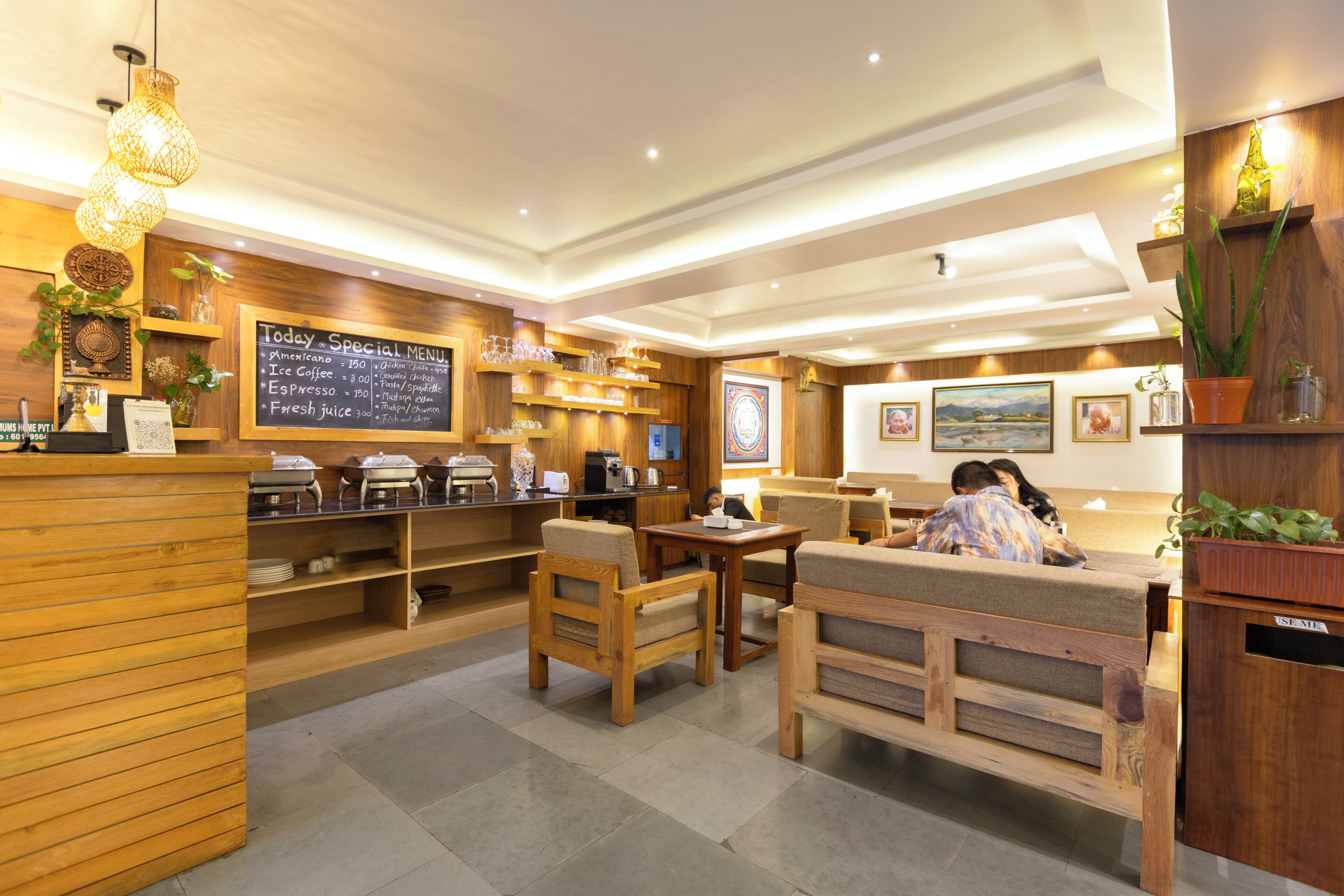 A restaurant with wooden furniture, a chalkboard menu, and a cozy atmosphere.