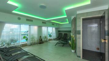 A waiting area with a reception desk, seating, a Buddha statue, and a view of the outdoors.