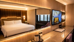 A hotel room with a large bed, a TV, a desk with a chair, and a window. - The Cloud Hotel Kaohsiung (Kaohsiung)