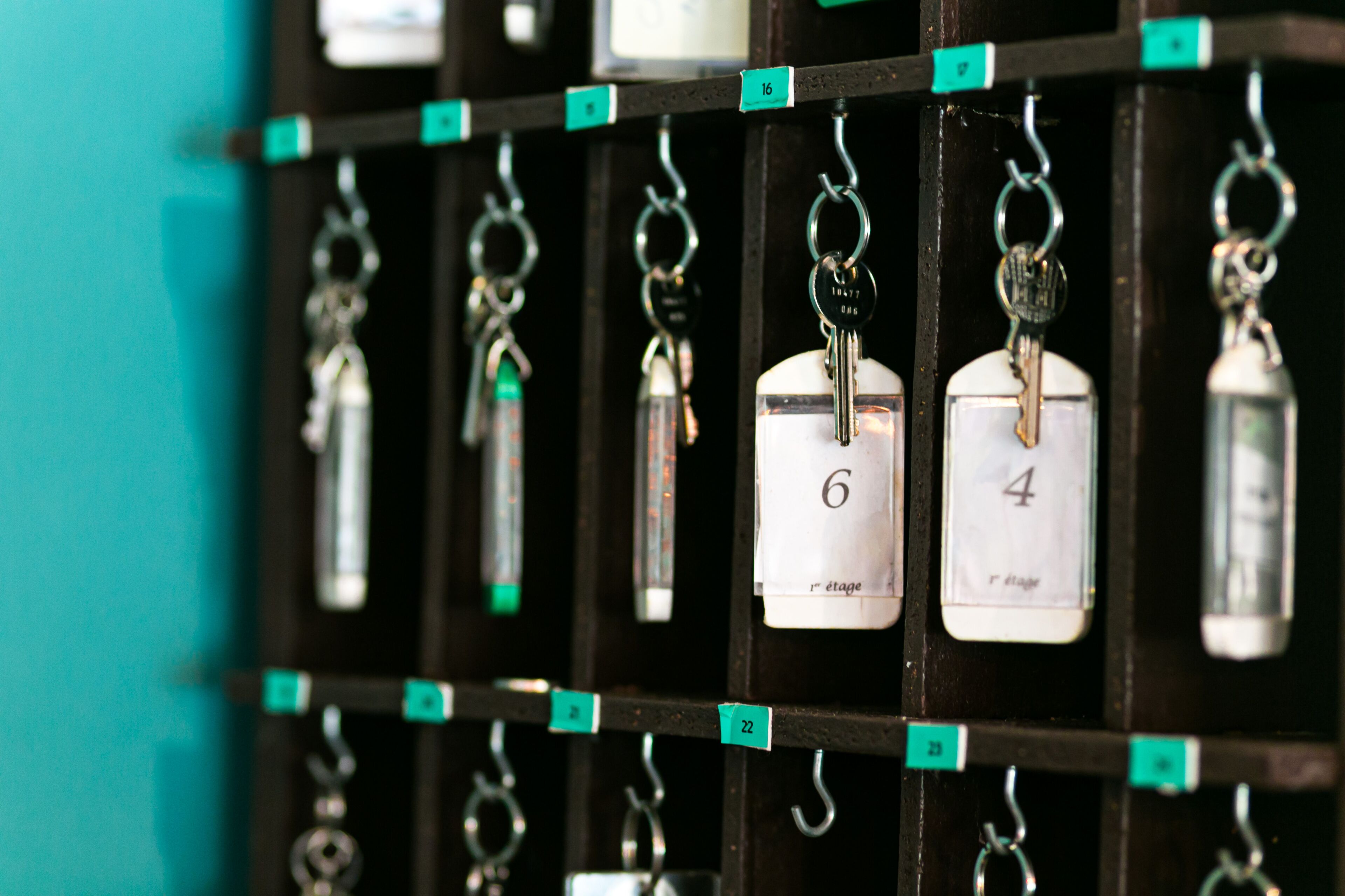 A wall with numbered hooks, each holding a key and a numbered tag.