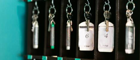 A wall with numbered hooks, each holding a key and a numbered tag.