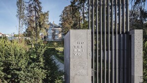 A hotel entrance with a concrete pillar displaying "HOTEL PRIVO" and a metal gate. - Villa Csonka by Hotel Privo (Targu Mures)
