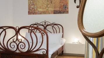 A bedroom with a wooden bed, a large mirror, and a colorful abstract painting on the wall.