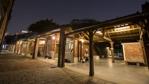 An outdoor covered area with benches and a brick wall, likely a public space or waiting area. - Wholesome Hotel  (Taipei)