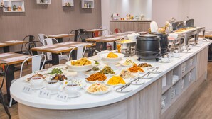 A buffet setup with various dishes and utensils. - Wholesome Hotel  (Taipei)