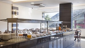 A modern breakfast bar with a long counter, glassware, and a variety of breakfast items. - Master Express Dom Pedro II (Porto Alegre)