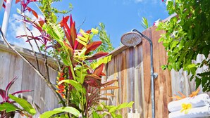 A wooden fence with a wooden post and a metal showerhead. - Tet Rouge Resort St. Lucia (Choiseul)