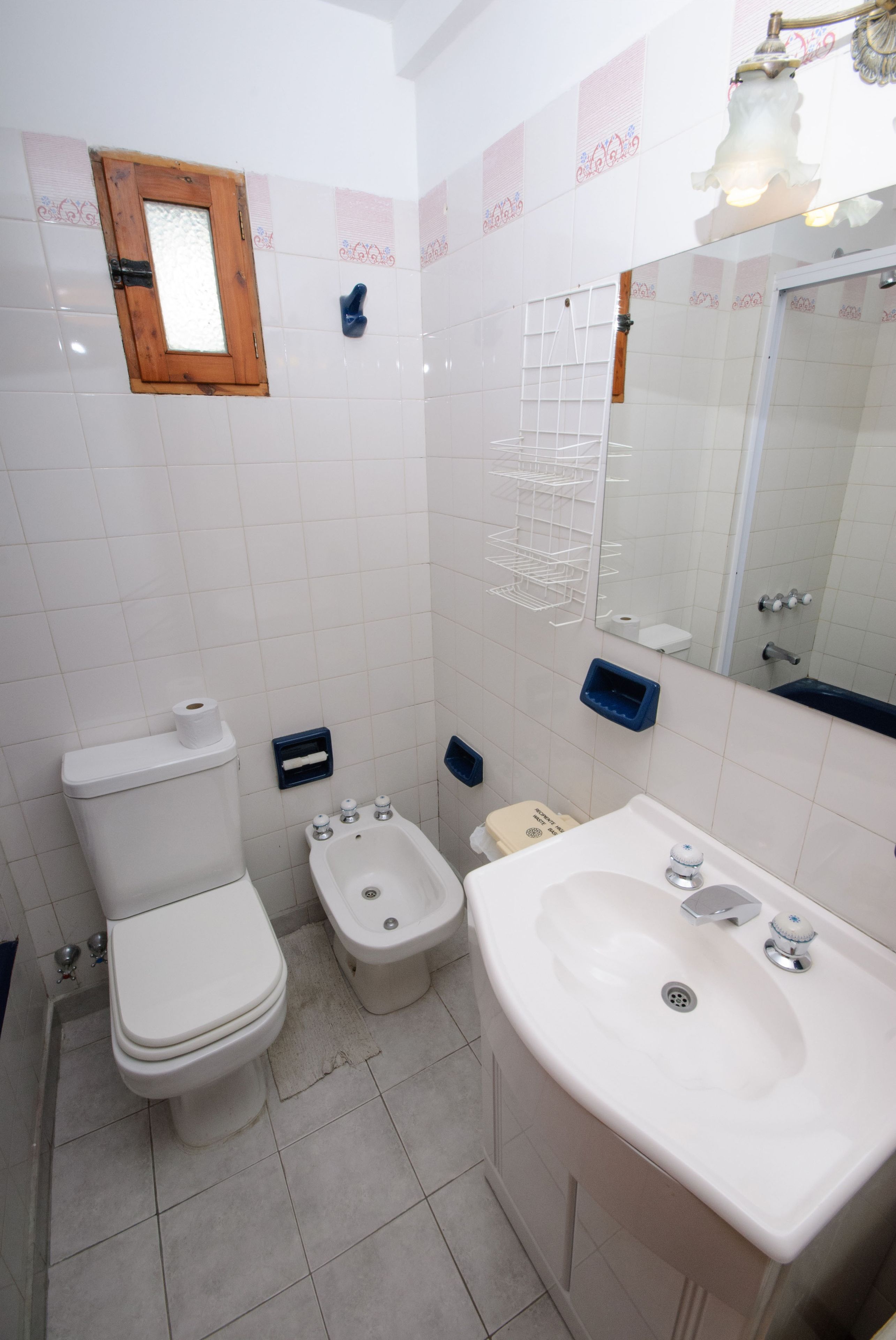 A bathroom with a toilet, bidet, and sink.