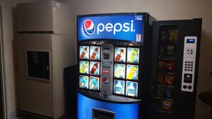 A vending machine with a Pepsi logo and various beverage options. - Briarwood Inn (Fairfield)