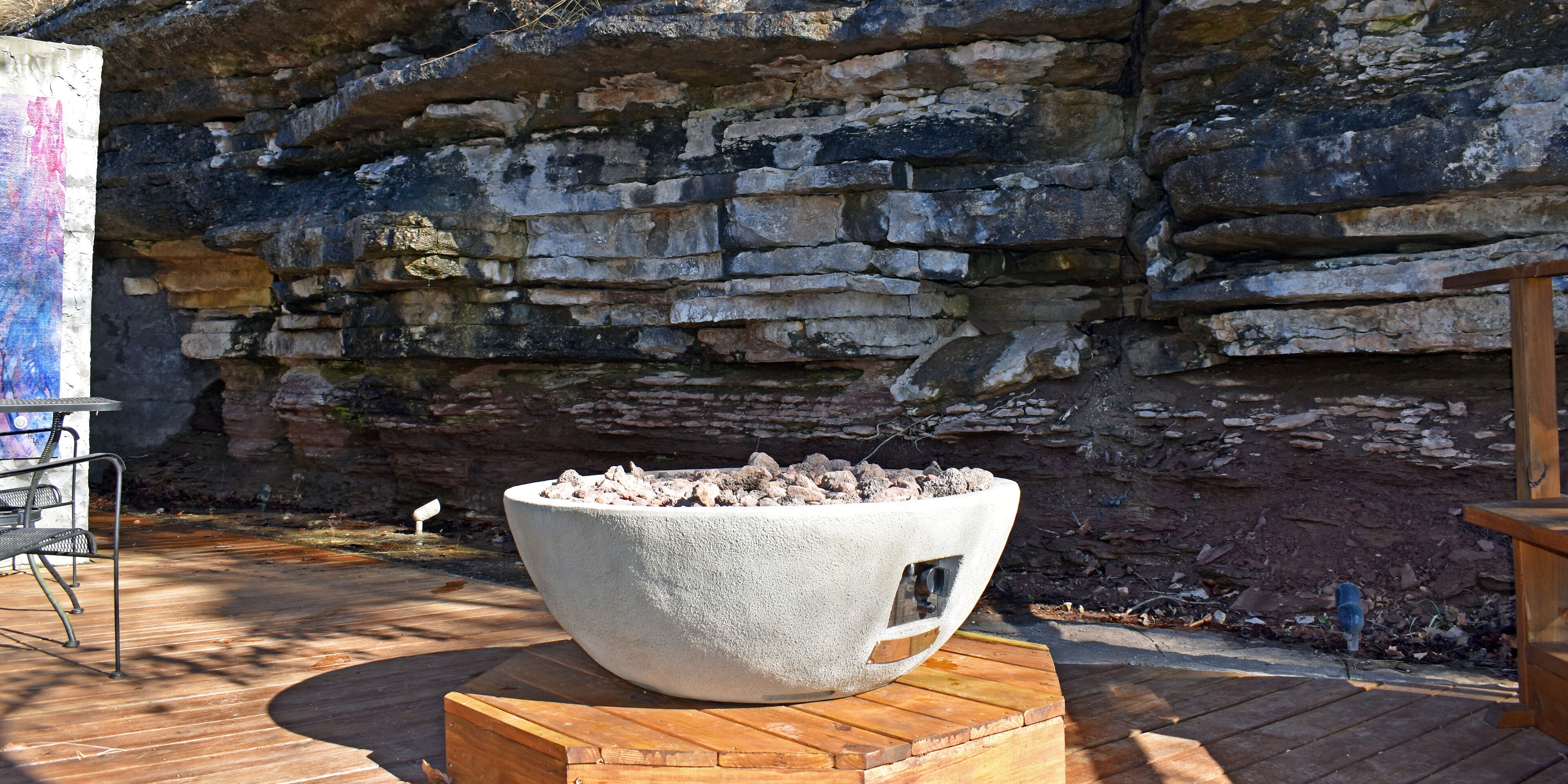 A stone wall with a fire pit in the center.