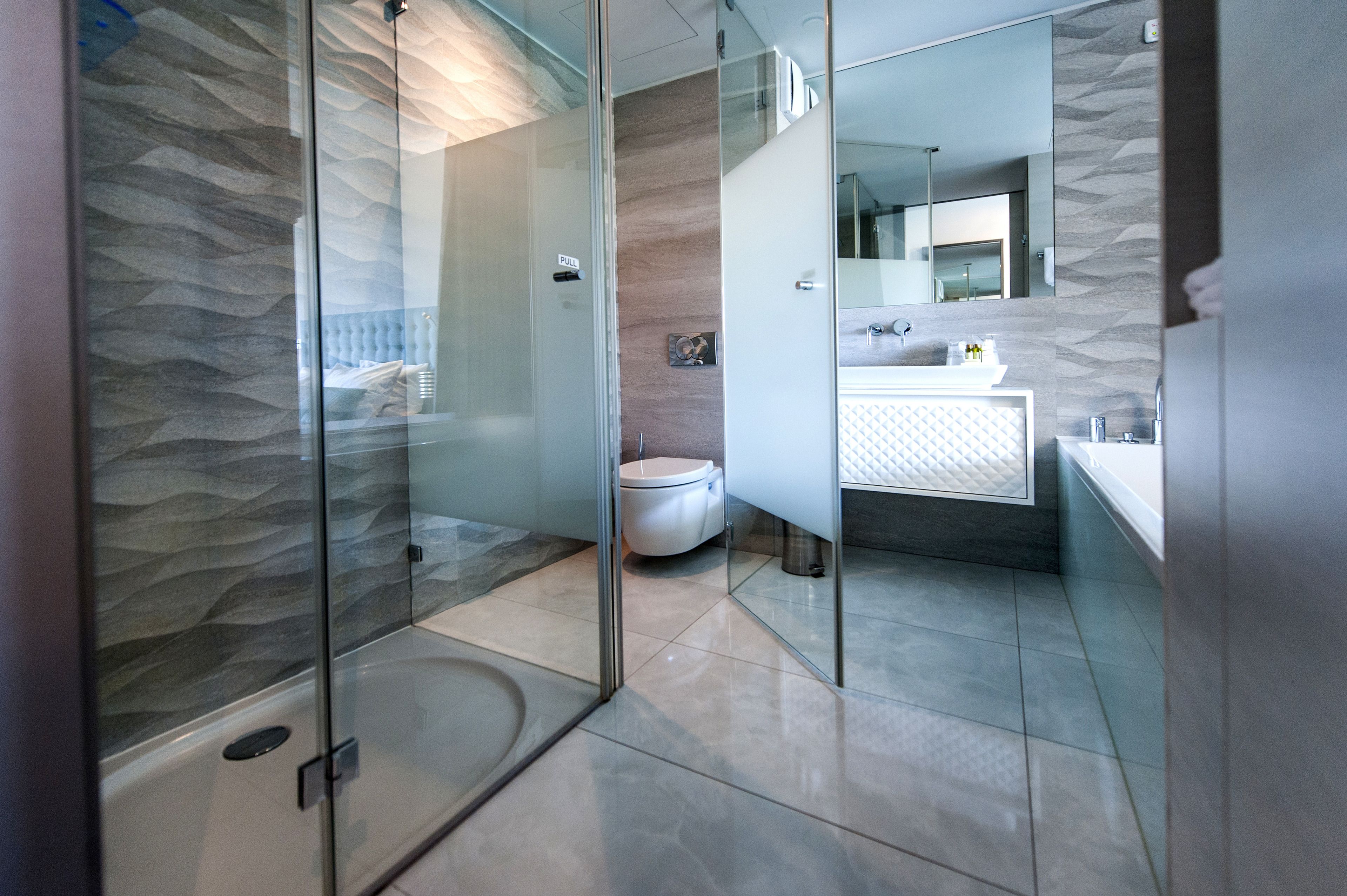 separate bathtub and shower, rainfall showerhead, designer toiletries