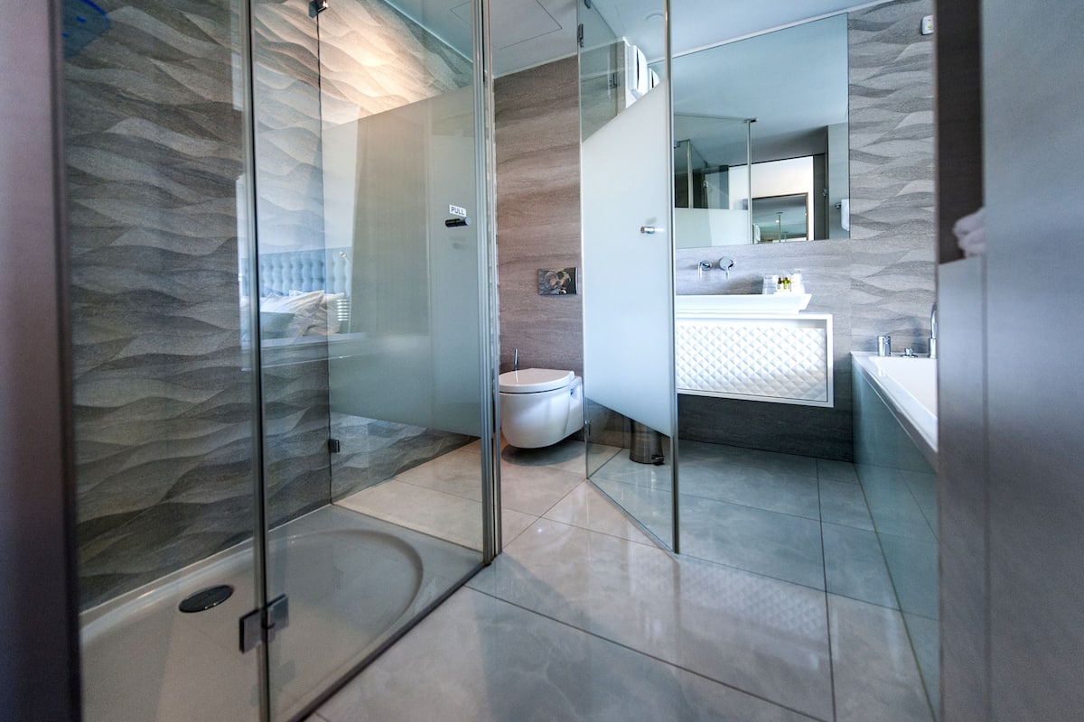 separate bathtub and shower, rainfall showerhead, designer toiletries