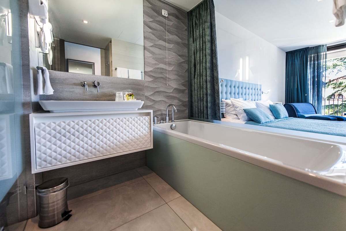 separate bathtub and shower, rainfall showerhead, designer toiletries