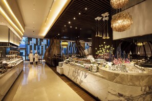A modern hotel lobby with a marble reception desk, a staircase, and a buffet area. - Crowne Plaza Fuzhou Riverside by IHG (Fuzhou)