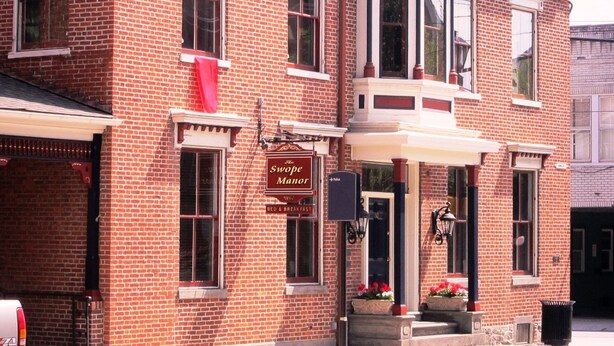 A brick building with a sign reading "The Swope Manor Bed & Breakfast." - The Swope Manor Bed & Breakfast (Gettysburg)
