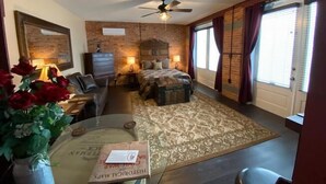 A bedroom with a bed, a dresser, a desk, a chair, a ceiling fan, and a window with curtains. - The Swope Manor Bed & Breakfast (Gettysburg)